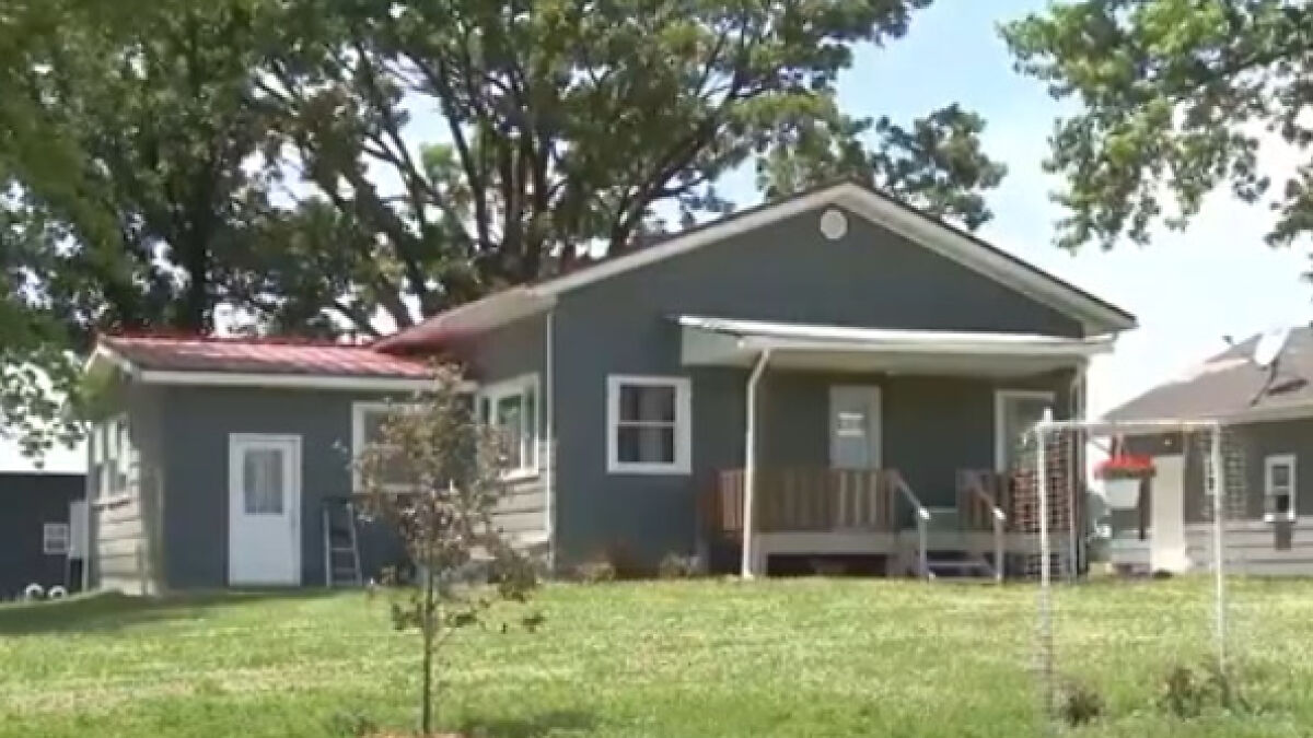 Small blue house at a Bible study camp where police rescued 88 children amid abuse and human trafficking investigation.