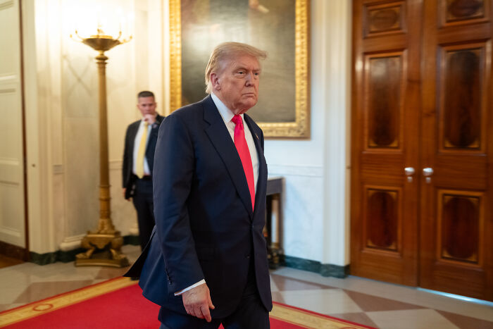 Former President Donald Trump walking in a formal setting, relates to swing-vote Murkowski’s decisive yes on GOP bill. Former President Donald Trump walking in a formal setting, relates to swing-vote Murkowski’s decisive yes on GOP bill.