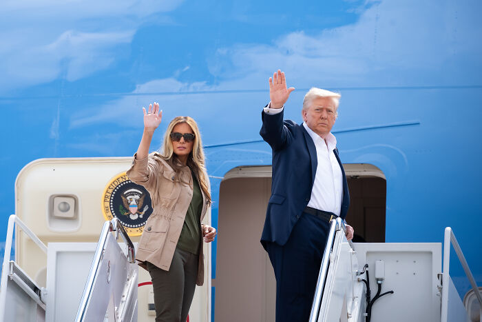 Former President Donald Trump and Melania Trump waving while boarding Air Force One, related to Barron Trump’s U.S. citizenship debate.