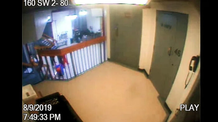 Surveillance footage of jail hallway showing an orange figure near cell area before Jeffrey Epstein’s death.