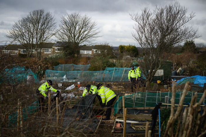 Police officers investigating an outdoor area related to aristocrat Constance Marten and partner Mark Gordon case.