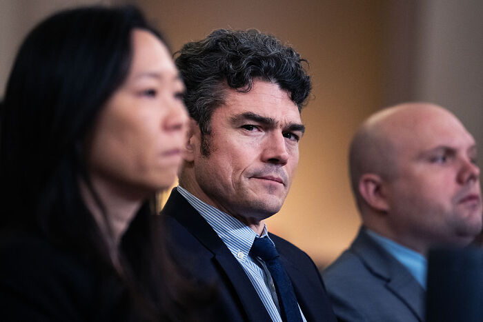 Joe Kent in a formal meeting, wearing a suit and tie, discussed in context of national counterterrorism center leadership.
