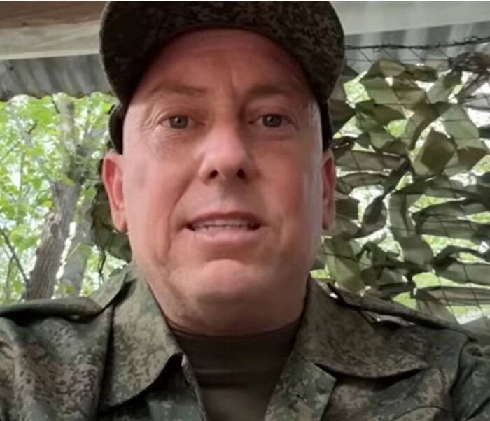Man in military uniform outdoors, representing dad of three sent to front lines in Putin’s Ukraine war.