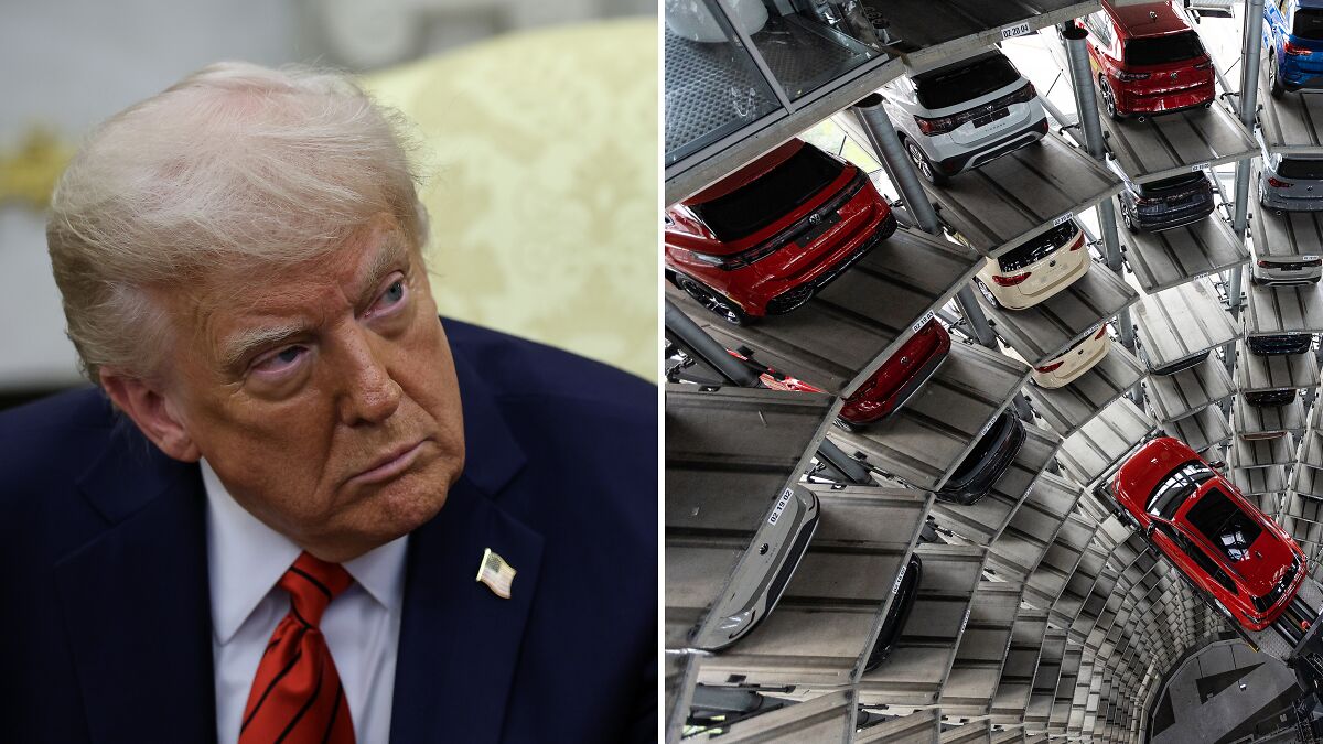 Donald Trump listening during a meeting next to stacked European cars in a multi-level parking structure.