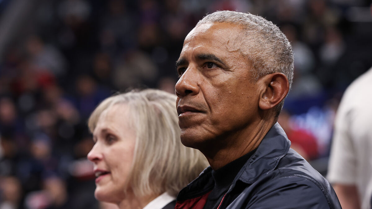 Barack Obama attending an event, focused and serious, relating to Trump treason allegations controversy.
