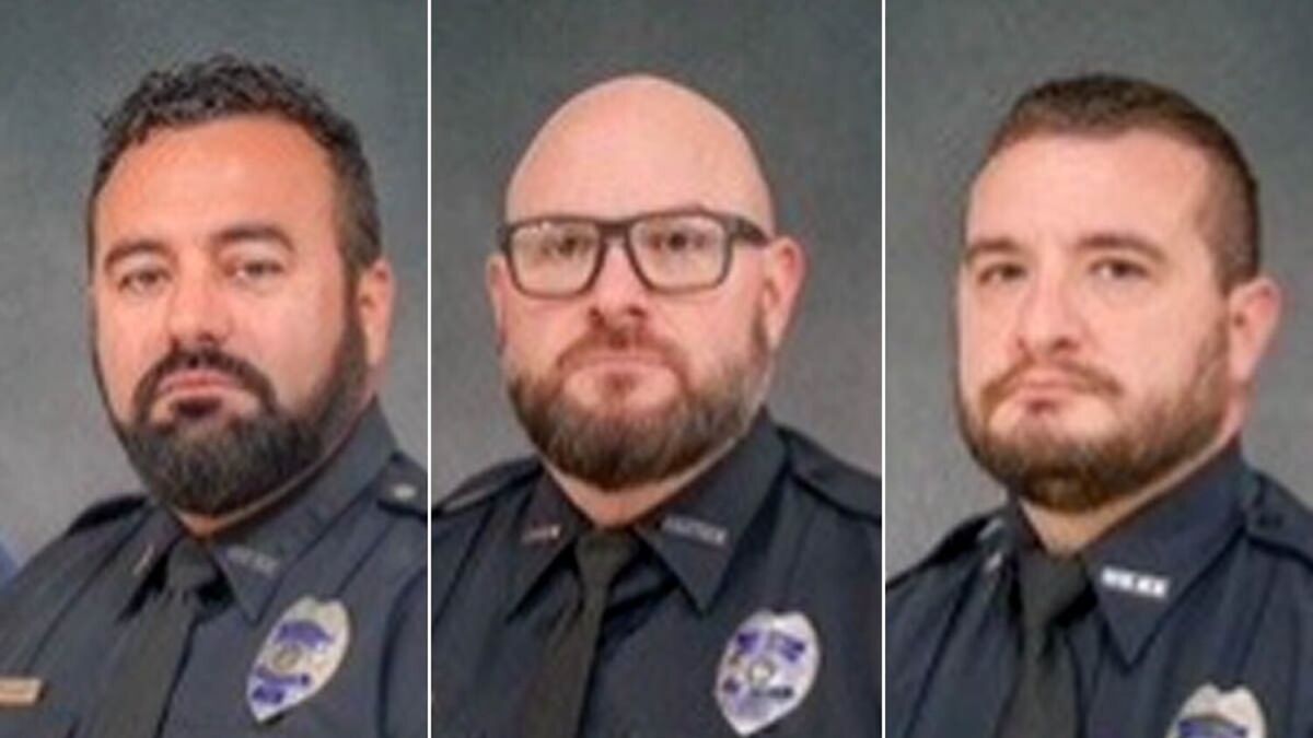 Three Ohio police officers in uniform, related to the Ohio police officer killed in ambush shooting case.