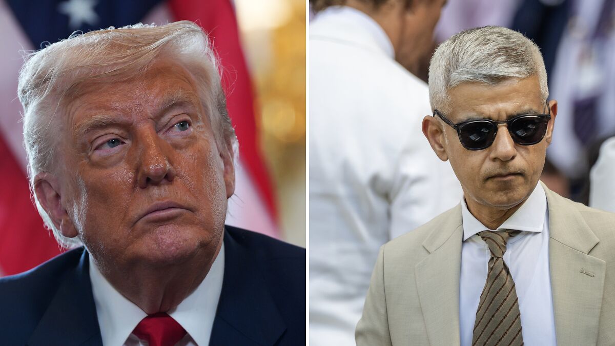 Donald Trump in a dark suit looking up beside London Mayor Sadiq Khan wearing sunglasses and a beige suit.