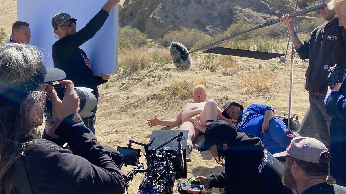 South Park on-set photo showing crew filming Donald Trump tiny manhood scene outdoors on sandy terrain.