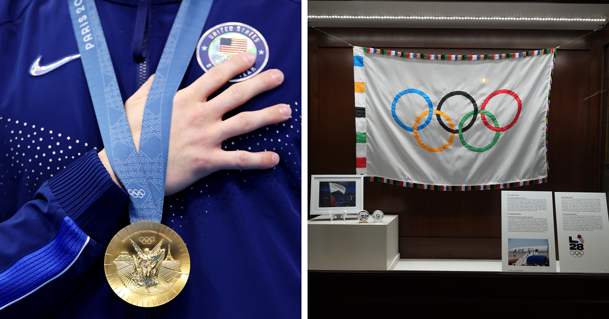 Close-up of U.S. Olympic athlete holding gold medal and Olympic rings flag displayed in a glass case at the museum.