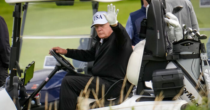 Former president Trump wearing a USA hat driving a golf cart at Turnberry amid viral cheating allegations in golf video
