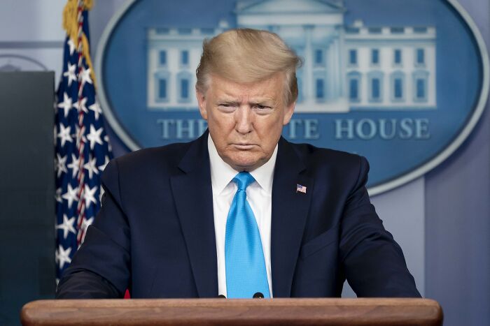 Donald Trump at White House podium during a press briefing about labor statistics and the weak jobs report.