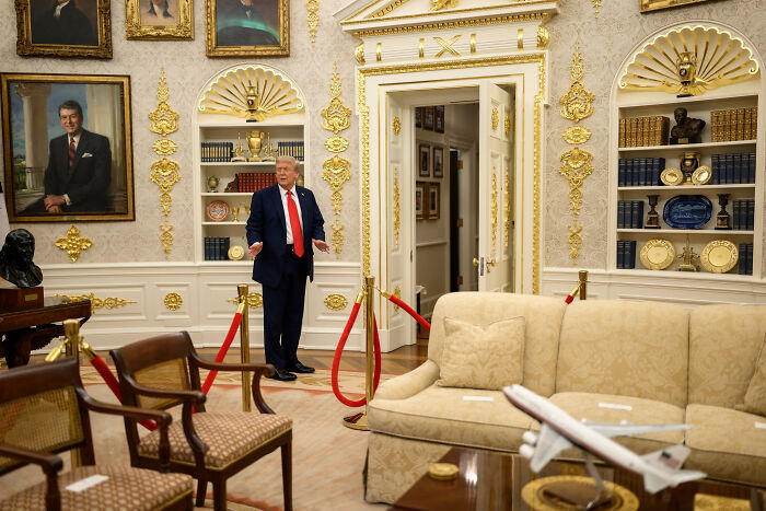 Former President Trump standing in the ornate Oval Office with golden decor and classic furniture visible around him. Former President Trump standing in the ornate Oval Office with golden decor and classic furniture visible around him.