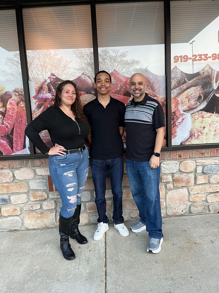 Three people standing outside a restaurant, representing family mentioned in Giovanni Pelletier body discovery story.