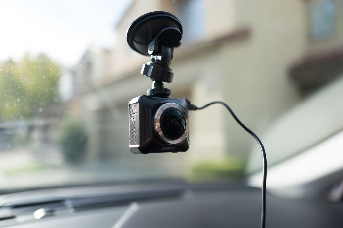 Dashboard camera mounted inside car, highlighting driver screening concerns linked to Uber’s alleged safety failures.