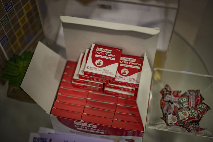 Boxes of latex condoms displayed on a counter, highlighting access issues related to women’s reproductive rights and health cuts.