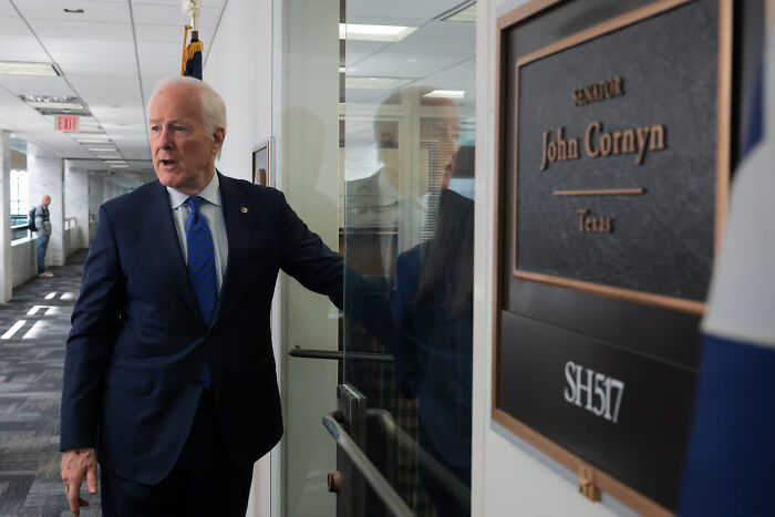 Texas senator entering office near nameplate, relating to FBI’s legal right question amid redistricting standoff.