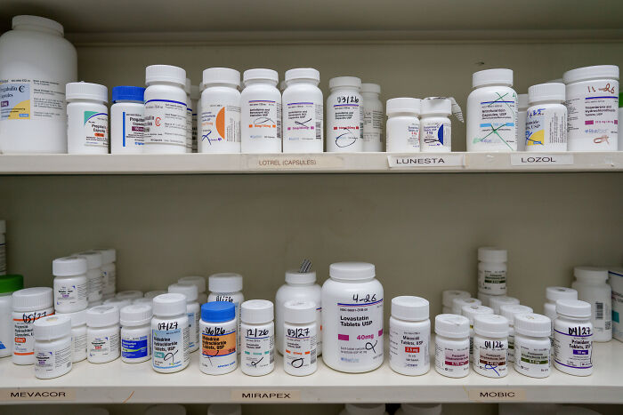Pharmaceutical bottles on shelves depicting challenges in drug pricing amid Trump’s big pharma gamble and policy shifts