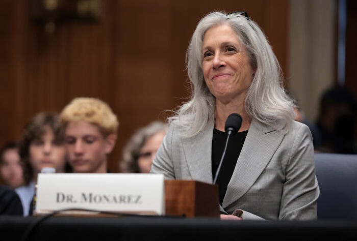 Dr. Monarez speaking at a hearing, wearing a gray blazer, highlighting CDC leaders amid RFK Jr. health plans concerns.