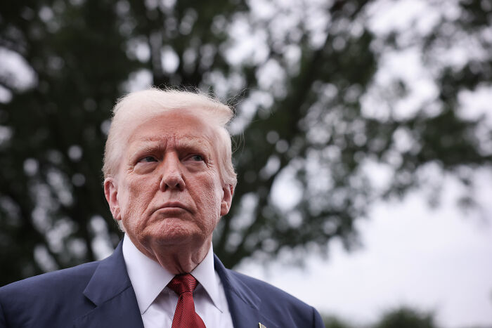 Former U.S. president outdoors looking serious, illustrating altered U.S. human rights report and Trump priorities.