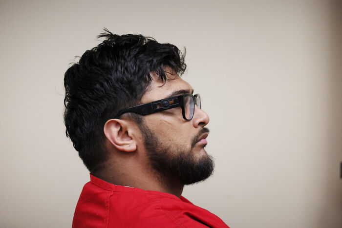 Man with beard and glasses wearing a red shirt in profile, related to Emmanuel Haro’s dad confessed case report.