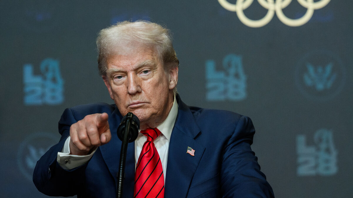 Donald Trump speaking at a podium, pointing, with emphasis on Big Pharma and drug pricing issues.