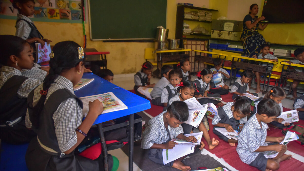 Children in a classroom reading books, illustrating the impact of children hospitalized after school water supply poisoning incident.