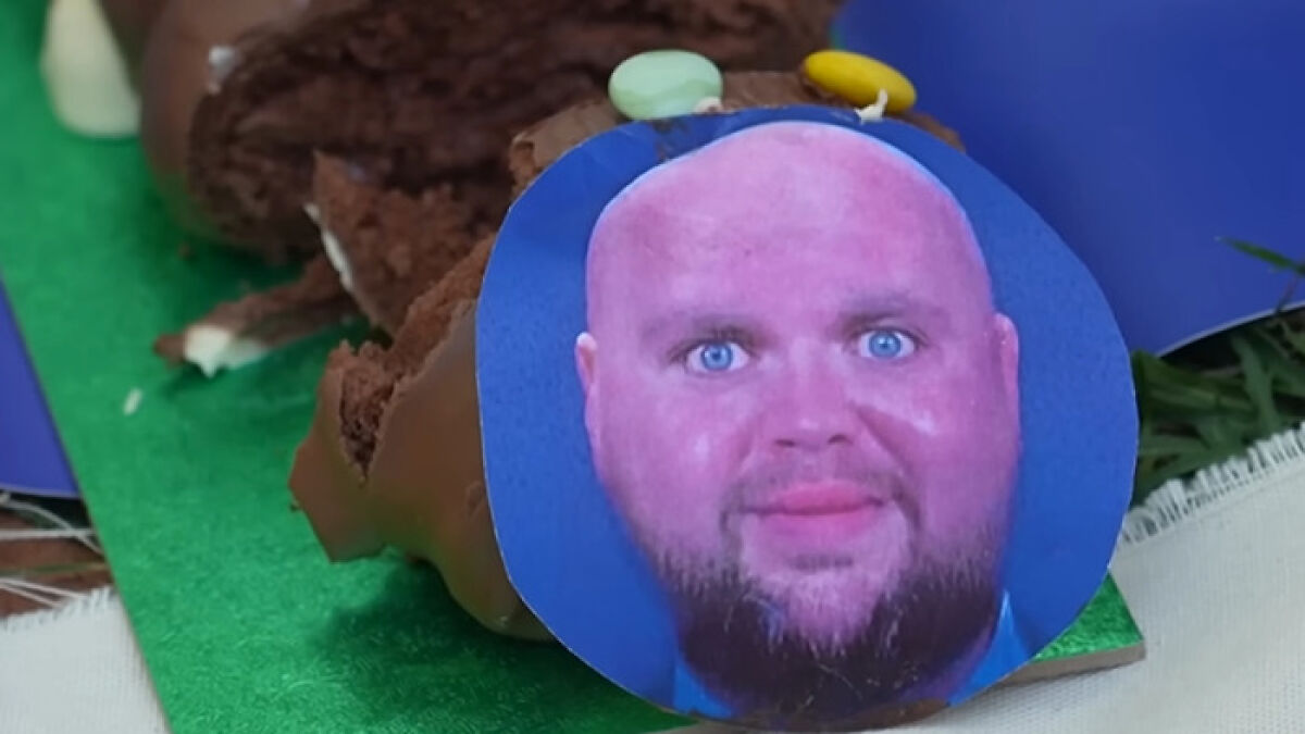 Cutout of D Vanceu2019s face on a chocolate dessert, related to villagersu2019 fury over disabled parking convoy incident.