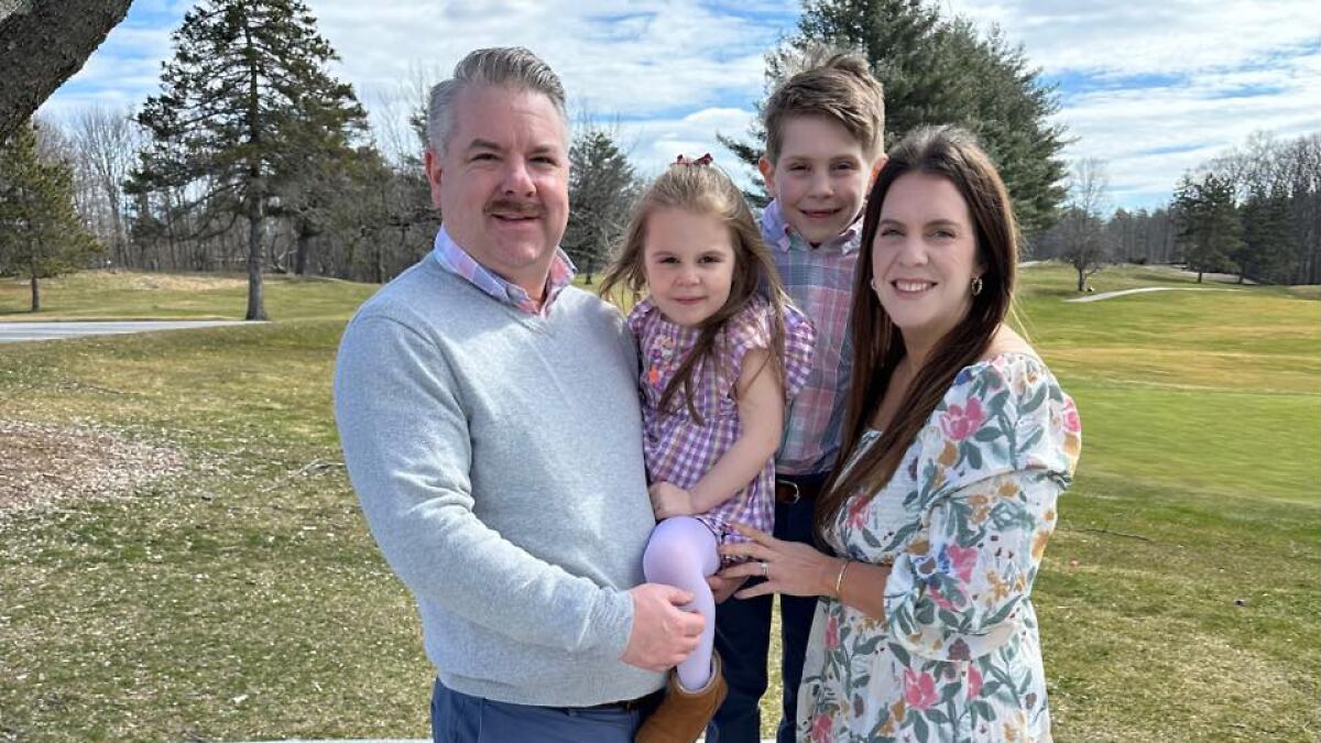 Family outdoors posing together, illustrating story about mom, husbandu2019s brain cancer, and tragic loss of kids and herself.