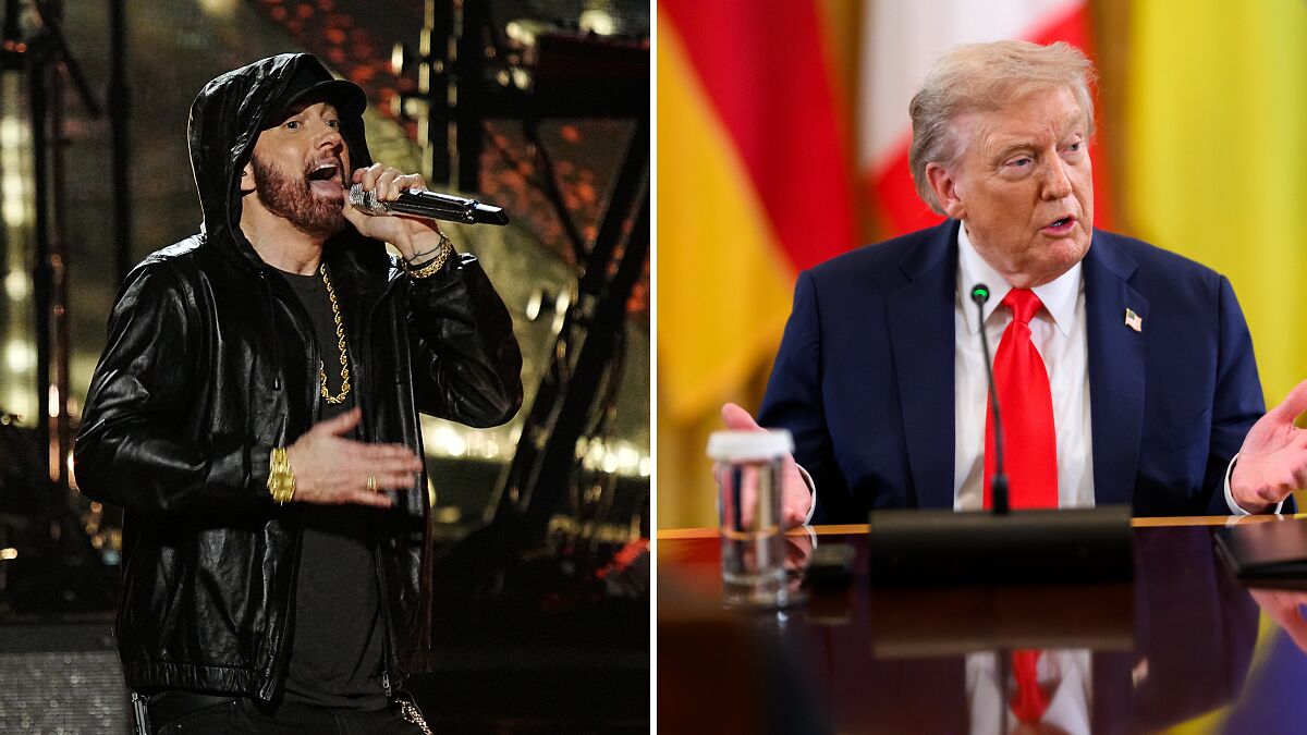 Eminem performing on stage in black hoodie next to image of Donald Trump speaking at a conference with MAGA flags.