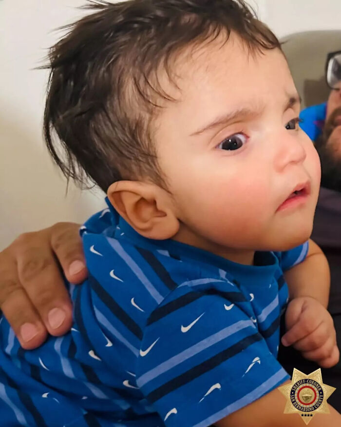 Close-up of baby Emmanuel Haro wearing a blue striped shirt, being held by an adult, related to tragic incident report.