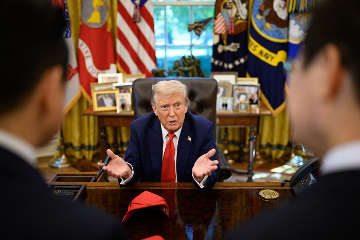 Donald Trump speaking in the Oval Office, with a red hat on the desk, amid controversy over domestic violence remarks. Donald Trump speaking in the Oval Office, with a red hat on the desk, amid controversy over domestic violence remarks.