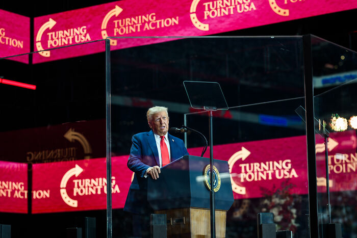Donald Trump speaking at Turning Point USA event, referencing late activist Charlie Kirk’s last request before assassination.