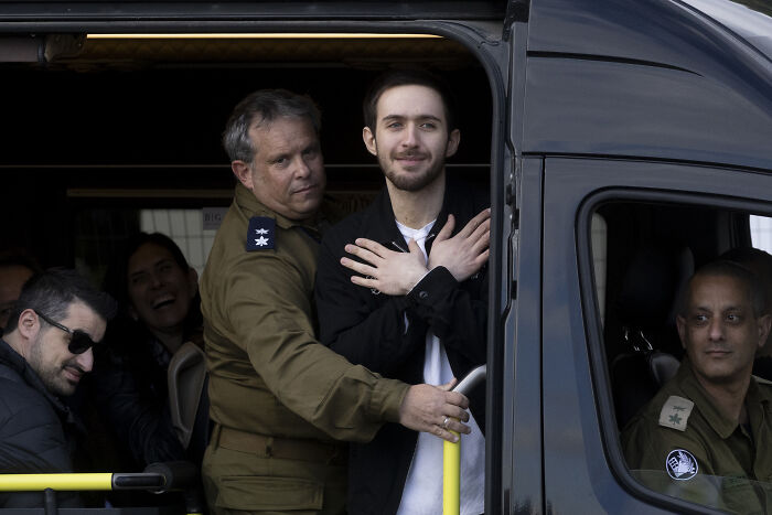 Man escorted by military personnel inside a vehicle, relating to controversy over free Palestine movement and hate groups. Man escorted by military personnel inside a vehicle, relating to controversy over free Palestine movement and hate groups.