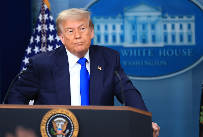 Former President Trump at White House press briefing, discussing border policy and related investigations.