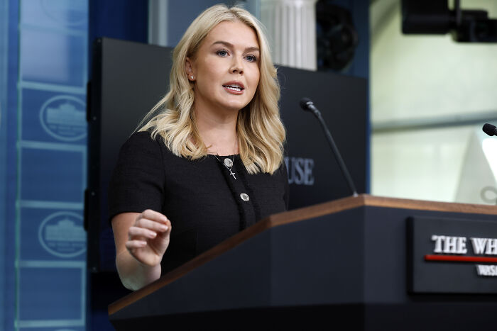 Karoline Leavitt speaking at a podium about Utah quake as a divine warning linked to Charlie Kirk assassination claims.