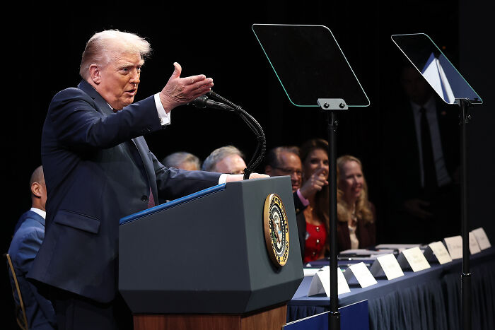 Donald Trump speaking at a podium with presidential seal, comments on domestic violence sparking fierce backlash. Donald Trump speaking at a podium with presidential seal, comments on domestic violence sparking fierce backlash.