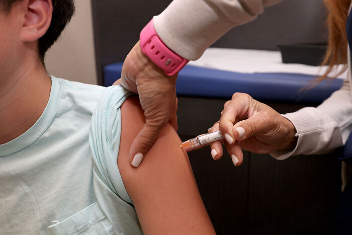 Person receiving a vaccine injection in arm, representing CDC director Susan Monarez resisting RFK Jr. vaccine plans controversy.