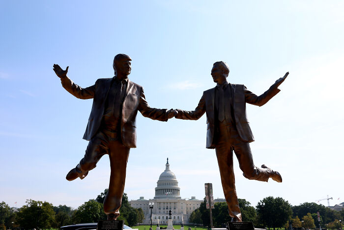 Bronze statue of Trump and Epstein holding hands and posing in front of the U.S. Capitol building in Washington D.C.