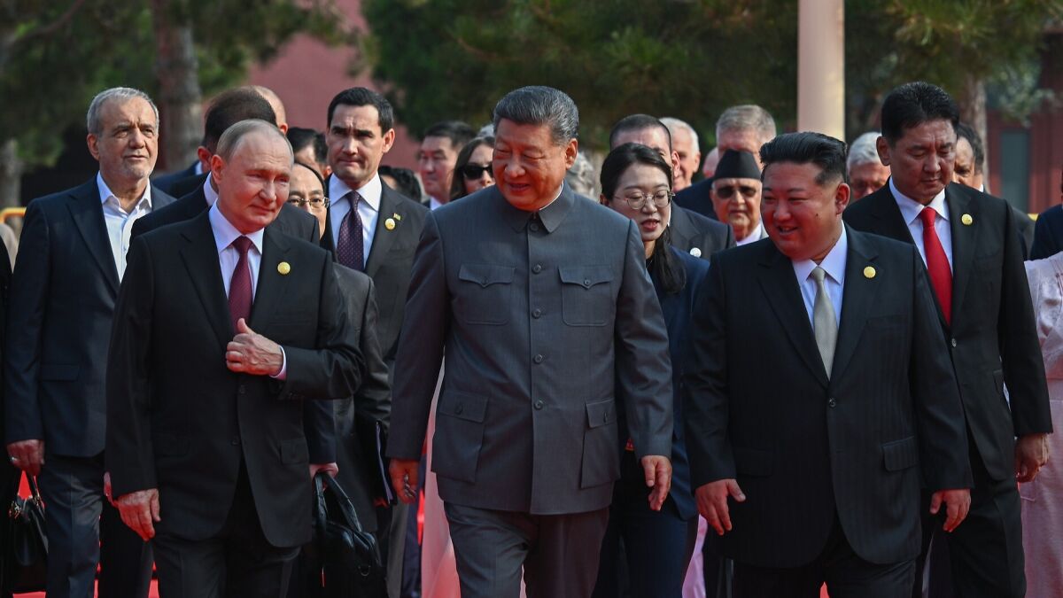Putin, Xi, and Kim walking together with delegates during a formal international event, highlighting global political tensions.