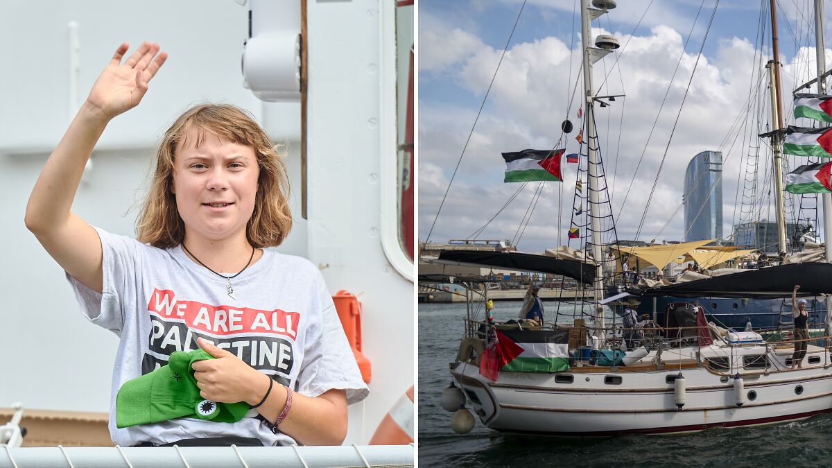 Greta Thunberg waving aboard Gaza flotilla ship with Palestinian flags sailing in harbor under cloudy sky.