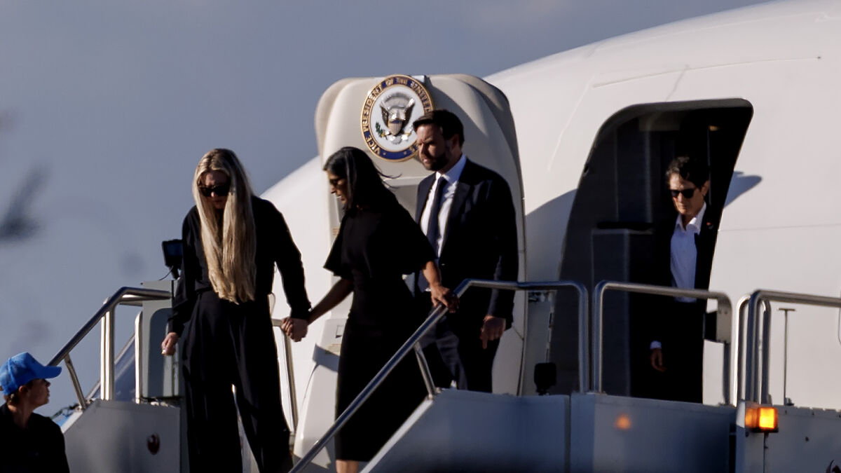 VP JD Vance and others disembark Air Force Two, transporting Charlie Kirk's casket home in a somber ceremony.