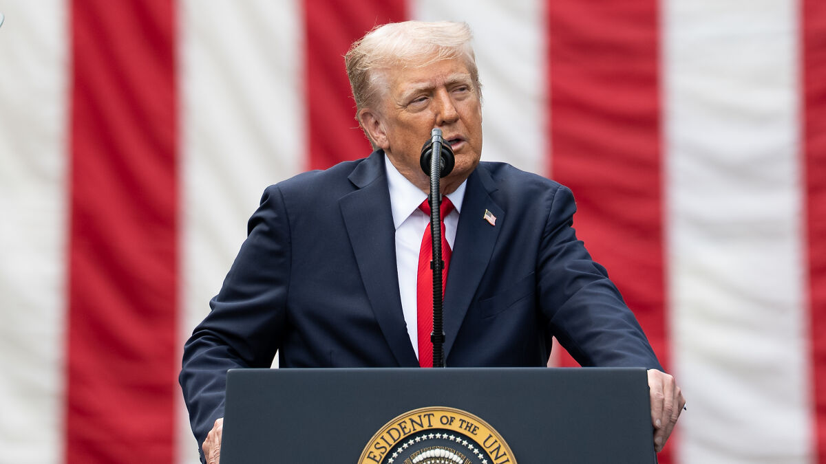 Donald Trump speaking at a podium with the presidential seal and an American flag backdrop.