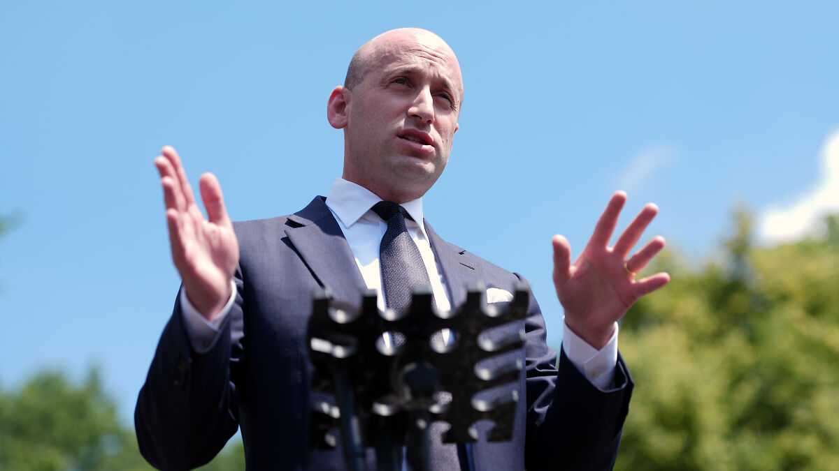 Stephen Miller outdoors speaking at a podium during a press event on plans to target left-wing terror movement.