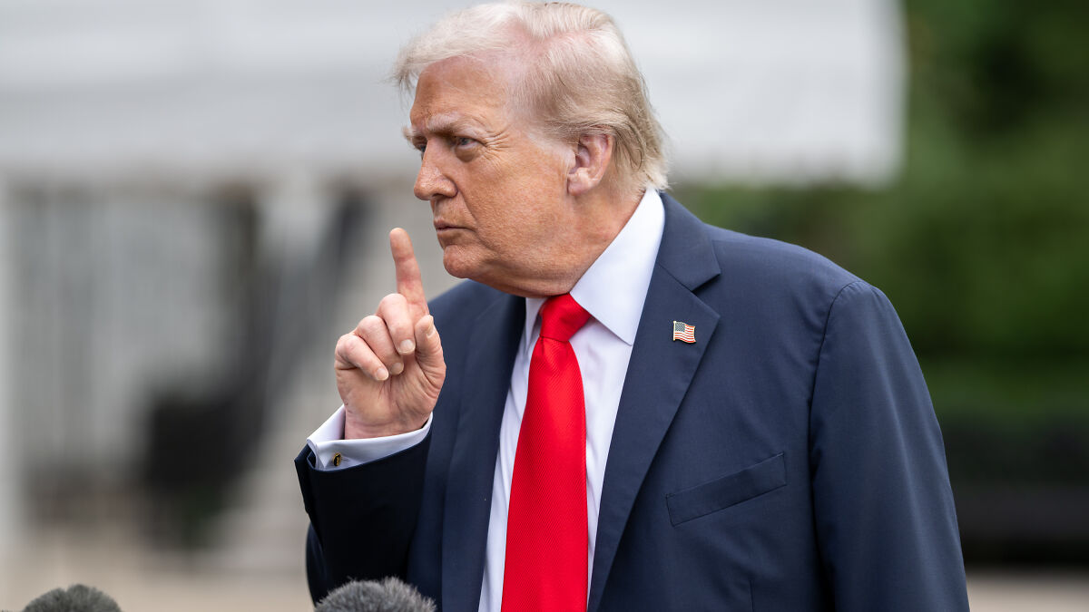 Donald Trump speaking outdoors with a raised finger, reacting to Jimmy Kimmel and ABC returning late-night host.