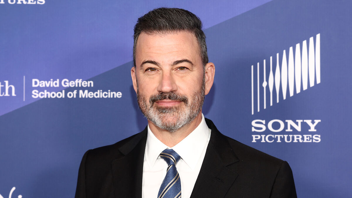 Jimmy Kimmel in a suit at an event, representing late-night host success and peak ratings after suspension.