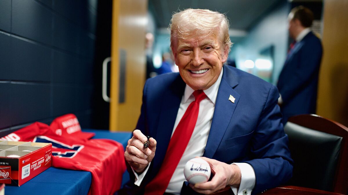 Donald Trump smiling in a suit and red tie holding a baseball, related to AI post and Medbed conspiracy theory.