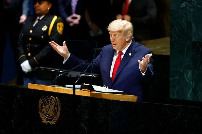 Speaker at United Nations podium addressing audience with a discussion on solar power plant boom in Africa development