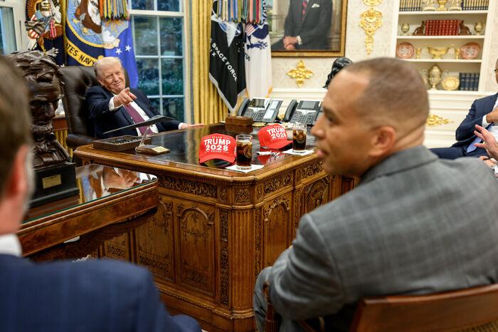 Former President Trump sitting in the Oval Office with Trump 2028 hats on the desk discussing strategy for a third term. Former President Trump sitting in the Oval Office with Trump 2028 hats on the desk discussing strategy for a third term.