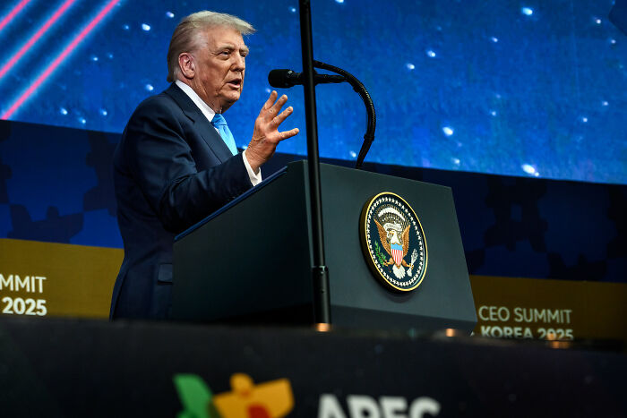 Former president speaking at a podium with presidential seal, addressing audience at APEC CEO Summit 2025. Former president speaking at a podium with presidential seal, addressing audience at APEC CEO Summit 2025.