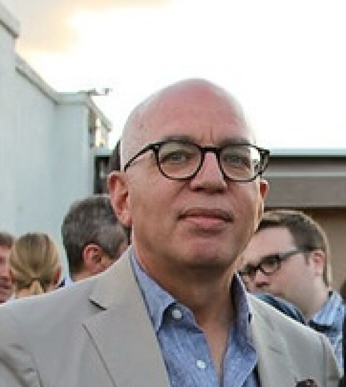 Michael Wolff wearing glasses and a beige jacket at an outdoor event, related to Trump biographer Epstein lawsuit news. Michael Wolff wearing glasses and a beige jacket at an outdoor event, related to Trump biographer Epstein lawsuit news.